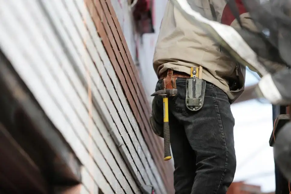 A roofer working on a residential roof